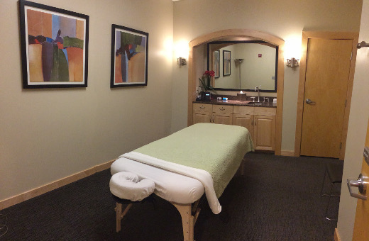 The massage room with massage table set up at Grant Park Condominium
